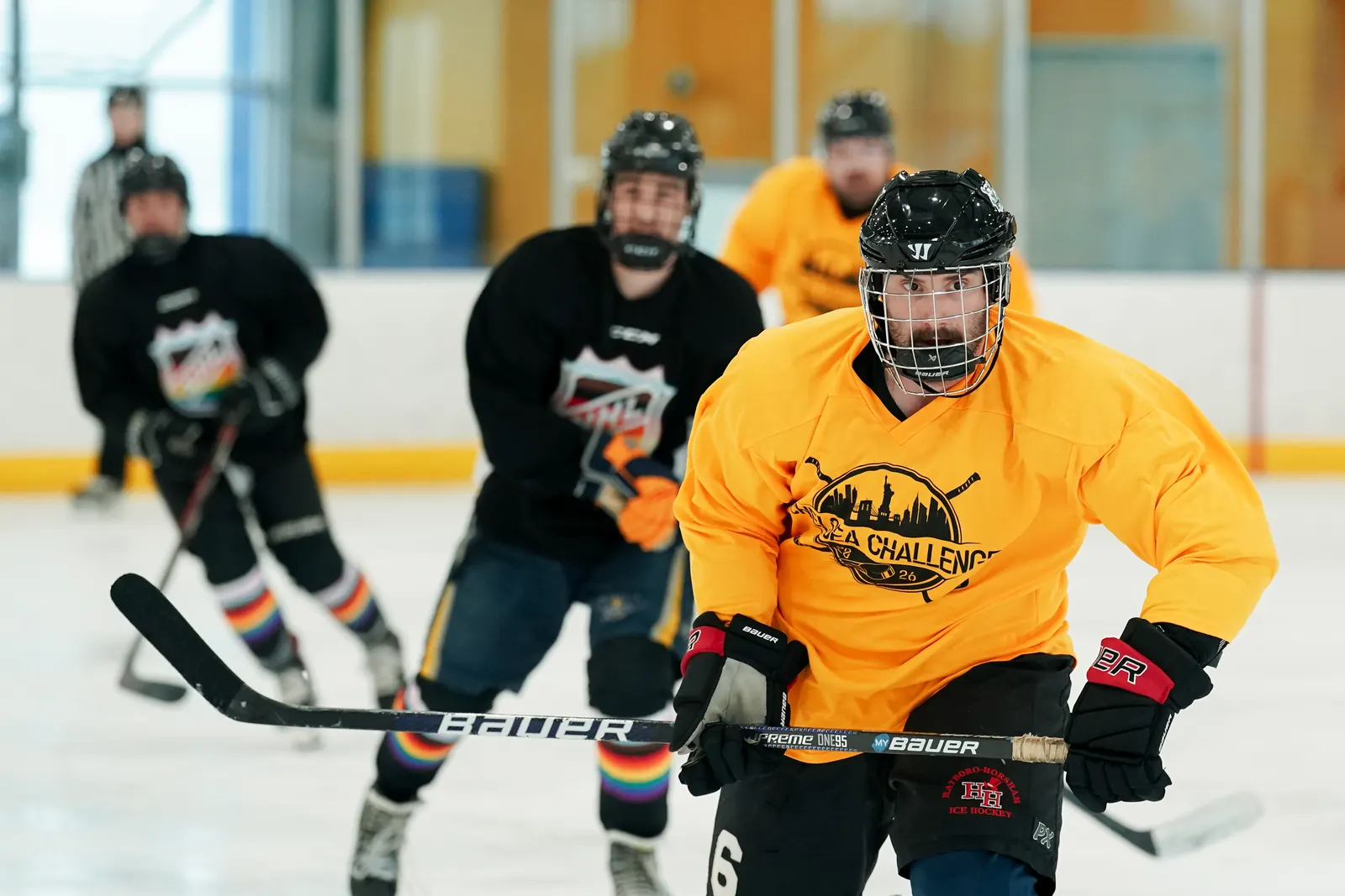 Whale Tailers player skates ahead of two opponents